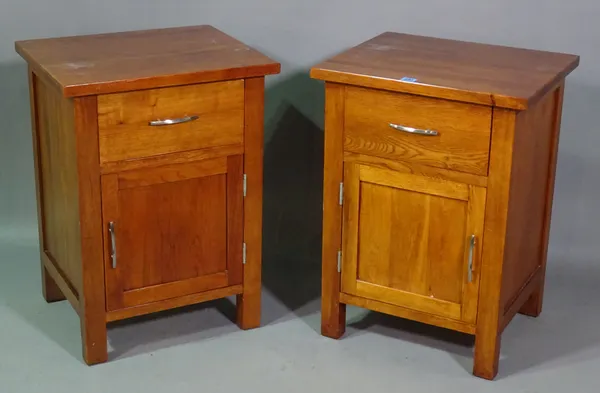 A pair of 20th century oak bedside cupboards with single drawer, 59cm wide x 66cm high (2).  G8