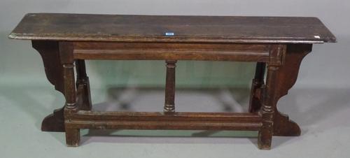 An 18th century and later oak rectangular bench, 130cm wide x 53cm high.   F8
