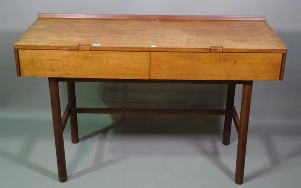 A 20th century teak rectangular dressing table with a pair of frieze drawers, 128cm wide and a stool, (2).   C8