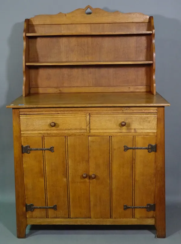 A 20th century oak dresser with two tier back over a pair of drawers and cupboards, 120cm wide.  K9