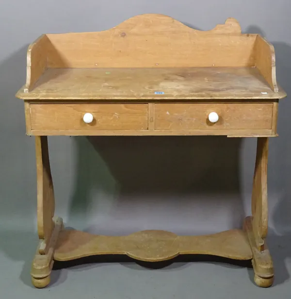 An early 20th century pine two drawer side table with galleried top, 92cm wide x 97cm high.   C8