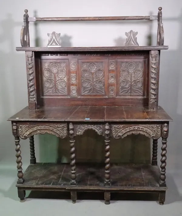 An 18th century and later oak side table with galleried back and inset carved panels, two drawers over platform undertier on block supports, 126cm wid