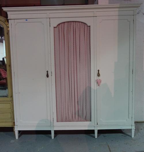 A 20th century white painted triple wardrobe on plinth base and square supports, 180cm wide x 192cm high.  M6