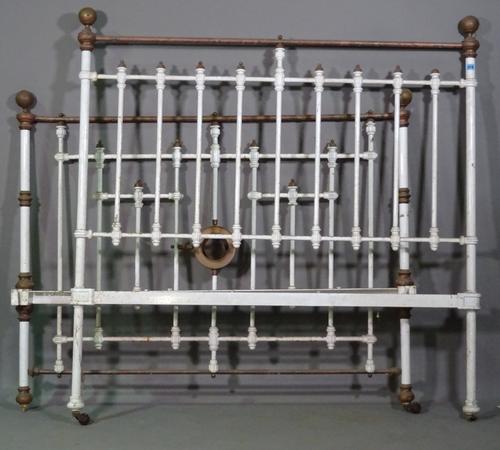 An early 20th century white painted double metal bed, 130cm wide x 140cm high.  L7