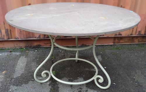 A hardstone topped circular conservatory table on scrolling cream painted metal base, 120cm wide x 76cm high.   OUT