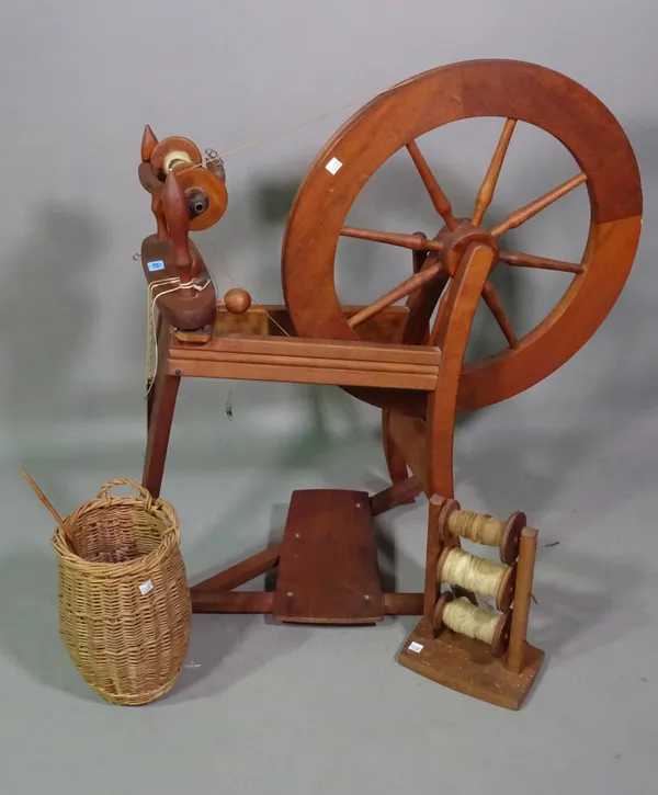 A 20th century mixed wood treadle spinning wheel, 70cm wide x 86cm high.   BAY 2