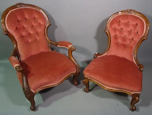 A Victorian gentleman's spoonback armchair on cabriole supports and a similar lady's chair, (2).   H8