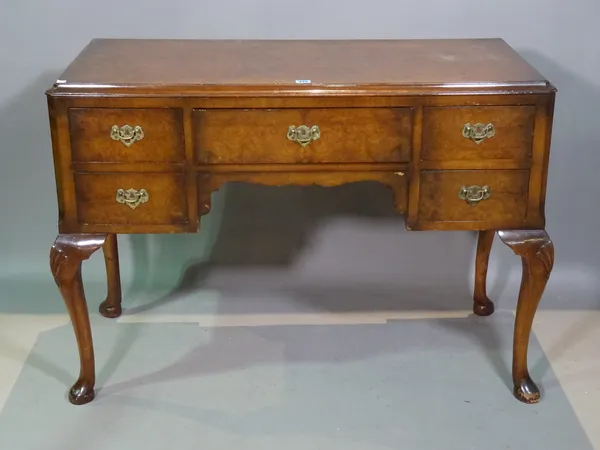 A George II style walnut kneehole desk on shell capped pad supports, 106cm wide x 77cm high, a 20th century mahogany rectangular 'X' frame footstool 5