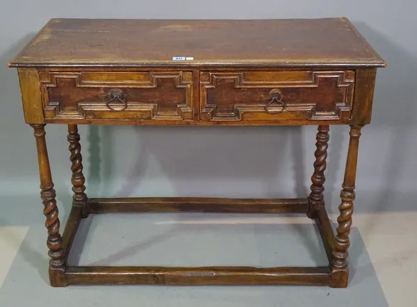 An 18th century and later oak two drawer side table on twisted supports, 97cm wide x 75cm high.   G6