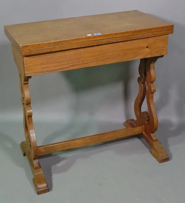 A Regency style oak card table on dual lyre supports, 77cm wide x 77cm high.   L7