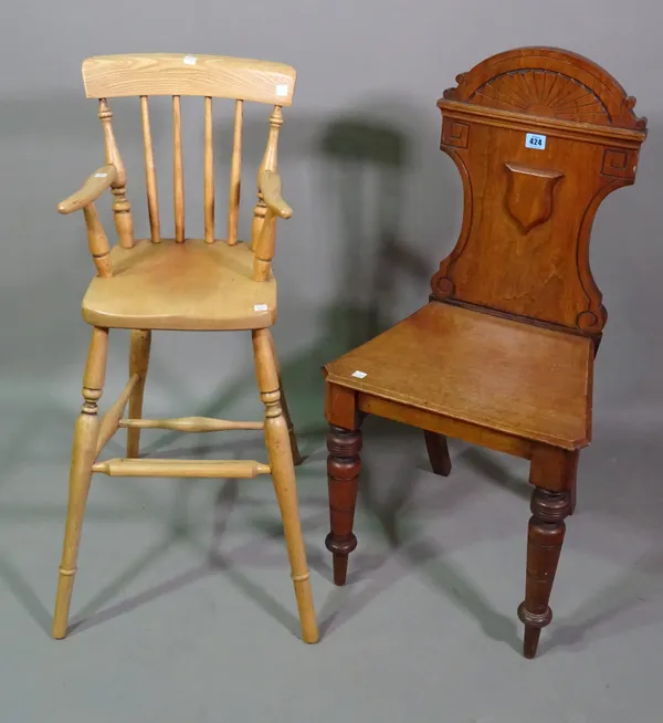 A Victorian mahogany shield back hall chair on ring turned supports and a 20th century child's oak high chair, (2).   L7