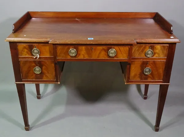 S & H Jewell; a 19th century mahogany breakfront kneehole desk with galleried top on tapering square supports, 108cm wide x 83cm high.   C6