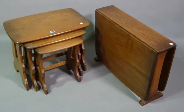 Ercol; a 20th century oak nest of tables, 57cm wide x 42cm high and a pair of white painted tripod tables, 46cm wide x 62cm high, (4).   M7