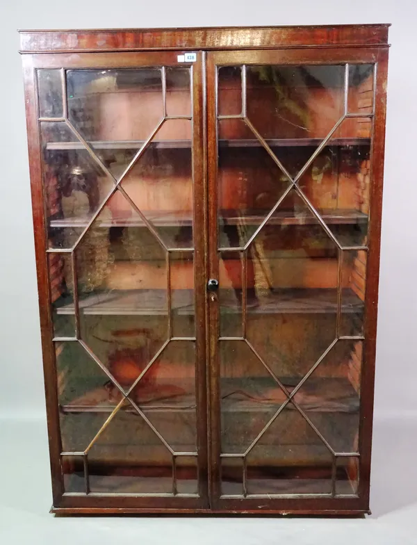 A George III style mahogany bookcase on stand with astragal glazed doors, 107cm wide x 180cm high.   F9