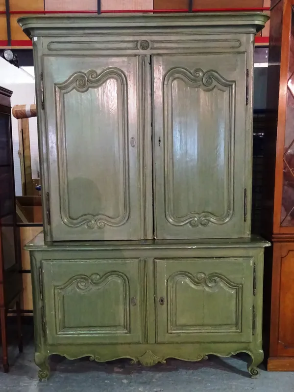A 19th century Continental green painted bookcase cabinet on scroll supports, 140cm wide x 205cm high.   M7