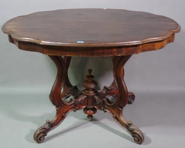 A Victorian mahogany serpentine centre table on four downswept scroll supports, 114cm wide x 74cm high.   BAY 1