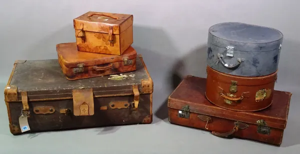 A group of six early 20th century leather suitcases of various sizes, the largest 90cm wide, to include two hat boxes, 43cm wide x 23cm high.   G7