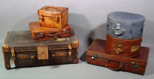 A group of six early 20th century leather suitcases of various sizes, the largest 90cm wide, to include two hat boxes, 43cm wide x 23cm high.   G7