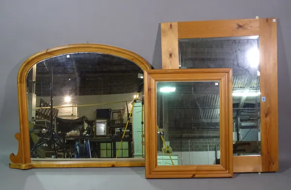 A group of three 20th century pine rectangular wall mirrors, the larger 118cm wide x 82cm high and a 20th century pine serpentine toilet mirror, 39cm