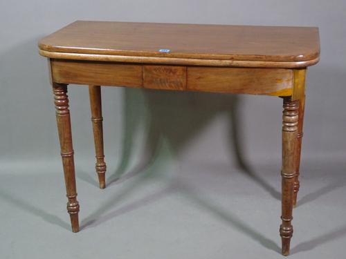 An early Victorian mahogany foldover tea table on ring turned tapering supports, 96cm wide x 76cm high. A4