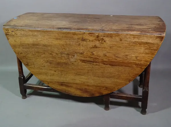 A late 18th century oak drop flap dining table, 130cm long x 72cm high.   BAY 3