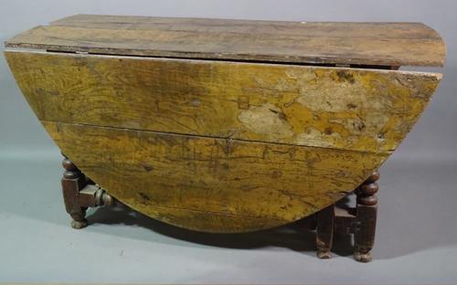 An 18th century and later oak drop flap oval dining table on bobbin turned supports, 153cm long x 75cm high.  H4