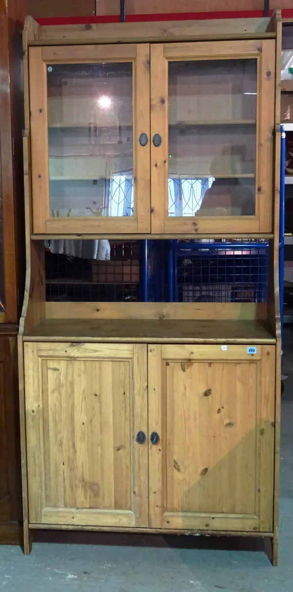 A 20th century pine cabinet with glazed upper doors over pair of paneled cupboards, 93cm wide x 200cm high.   M7