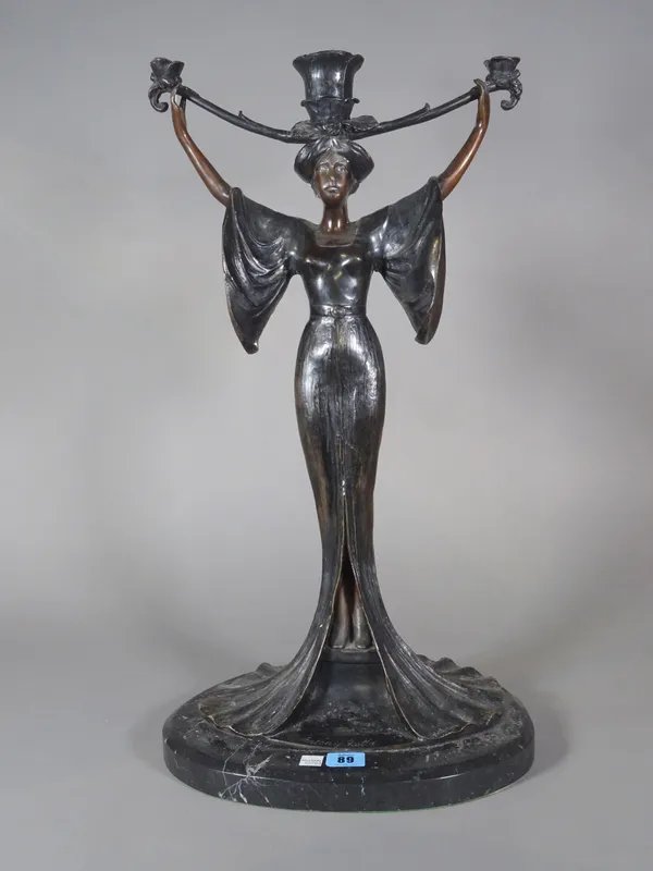An Art Nouveau style bronze figural candlestick, late 20th century, signed 'Antonio Rotta', modelled and cast as a female figure, arms raised, support