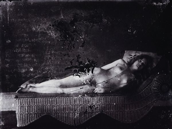 E.J. BELLOCQ  (1873 - 1949)  Woman reclining on a rattan couch, ca. 1912, from the Storyville, New Orleans series ca. 1911 - 1913., printed 1970s by L