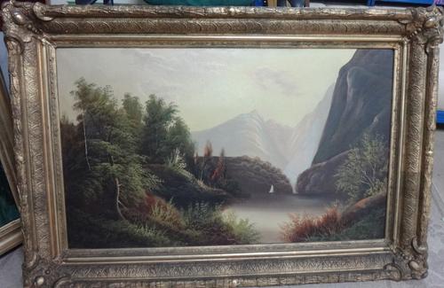 English School (c.1900), A wooded lake in a mountainous landscape, oil on canvas, 54cm x 90cm; together with a further oil of a figure on a riverside