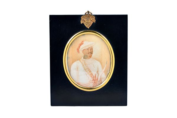 A late 18th/early 19th century Anglo-Indian 'Company School' portrait miniature on ivory of a gentleman wearing a flattened turban and red sash, holdi