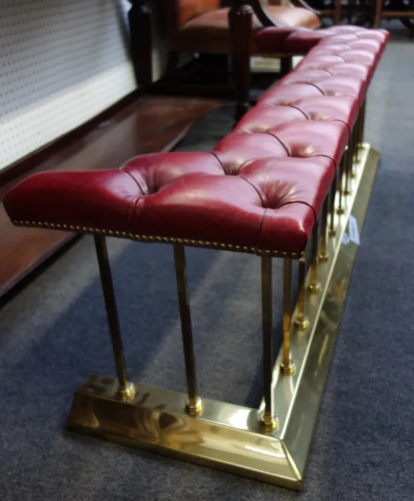 A Victorian style gilt metal and button back upholstered club fender, with square rails and a shaped kerb, 155cm wide.