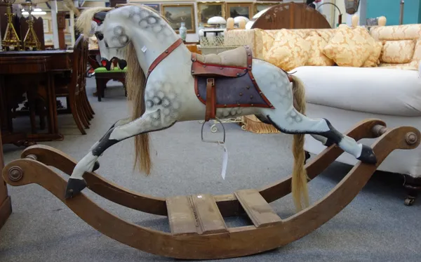 A child's wooden toy rocking horse, 20th century, dapple grey with leather tack, on a wooden bow rocker, 93cm high.