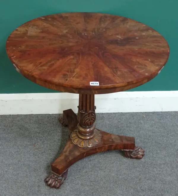 A Regency mahogany occasional table, the radial veneered circular snap top on reeded and carved column and three lions paw feet, 69cm diameter x 66cm