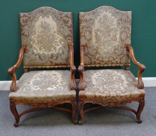 A pair of Continental 17th century style walnut framed hump back open armchairs, with 'X' frame supports, 68cm wide x 116cm high. (2)