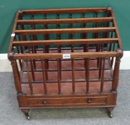 A Regency mahogany four division Canterbury, with spindle turned supports and single drawer base, 51cm wide x 39cm deep x 50cm high.