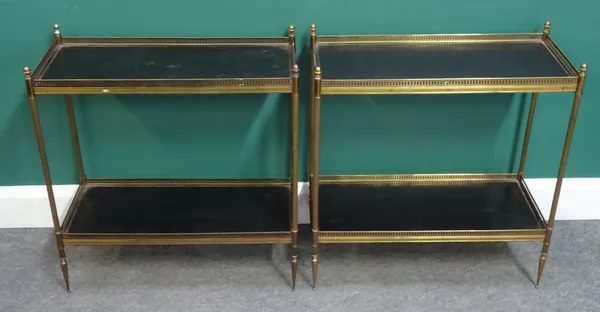 A pair of 20th century lacquered brass two tier étagères with leather inset platforms, 64cm wide x 29cm diameter x 68cm high. (2)