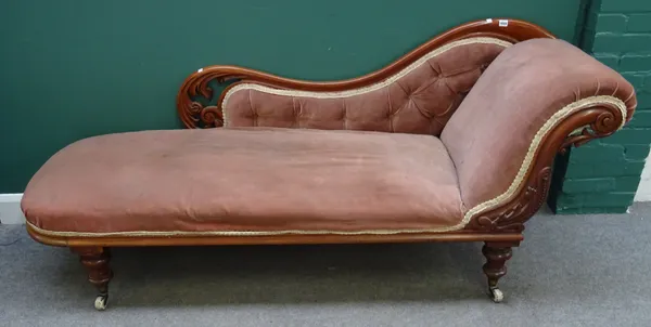 A Victorian mahogany chaise longue, with scroll end and carved frame, on turned supports, 200cm wide x 65cm deep.