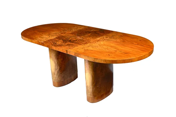 After Harry & Lou Epstein; a 1930s-1950s figured walnut oval extending dining table, on trestle supports, to include one extra leaf, 91cm wide x 153cm