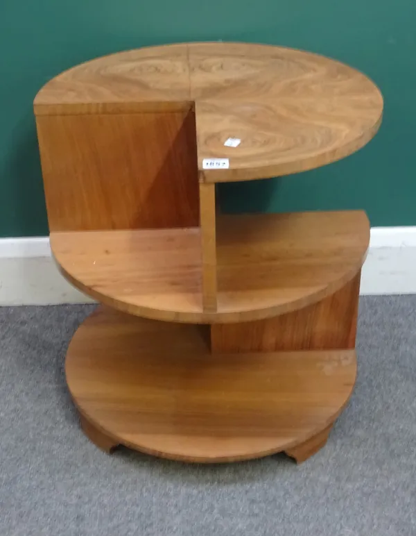 After Harry & Lou Epstein; a 1930s-1950s figured walnut circular three tier occasional table, with cut out segment decoration, 51cm wide x 53cm high.