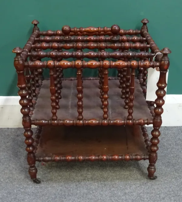 A Victorian bobbin turned fruitwood four division Canterbury, with platform undertier, 42cm wide x 47cm high x 34cm deep.