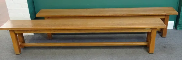 A pair of 20th century oak benches on canted block supports, each 30cm wide x 220cm long x 44cm high, (2).