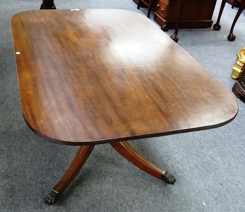 A Regency mahogany breakfast table, the rounded rectangular top over turned column and four downswept supports, 137cm wide x 88cm deep x 73cm high.