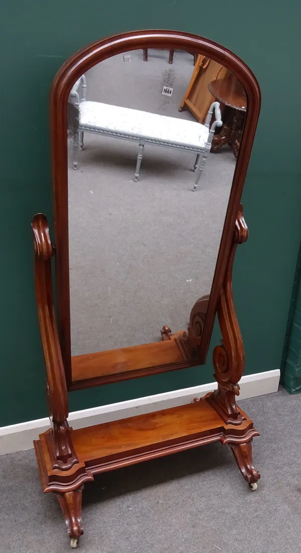 A Victorian mahogany framed cheval mirror, with arch top mirror plate and scroll supports, 95cm wide x 170cm high.