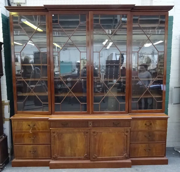 A George III style mahogany breakfront bookcase cupboard, the four astragal glazed doors over a long drawer and pair of cupboards, flanked by three gr