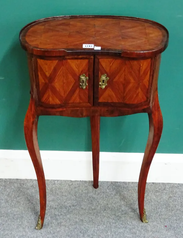 An 18th century French parquetry inlaid yew wood and tulipwood kidney shaped side table, the pair of doors enclosing five drawers, on gilt metal mount