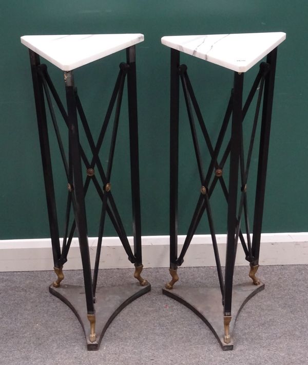 A pair of Egyptian Revival jardiniere stands, with triangular marble tops on black painted metal stands and gilt paw feet, 40cm wide x 100cm high. (2)