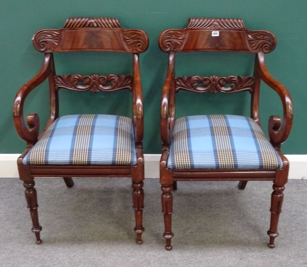 A pair of Regency style mahogany framed carver chairs with carved crest and waist rail, on lappet supports, 54cm wide x 90cm high, (2).