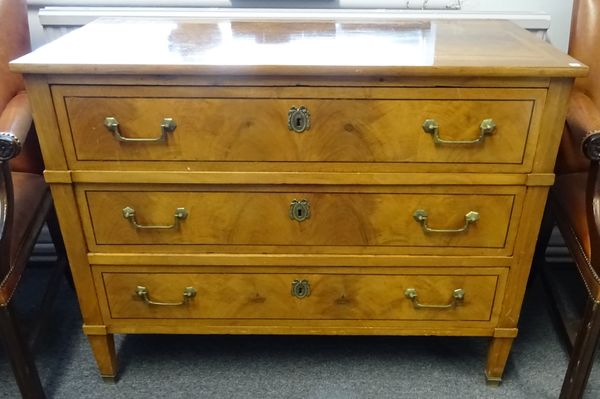 A Louis XVI style walnut and mixed wood three drawer commode, on tapering square supports, 113cm wide x 86cm high x 56cm deep.