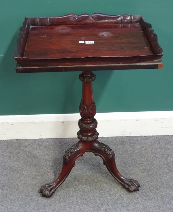 A William IV rosewood occasional table, the rectangular tray top on a carved tripod base and paw feet, 50cm wide x 72cm high x 40cm deep.